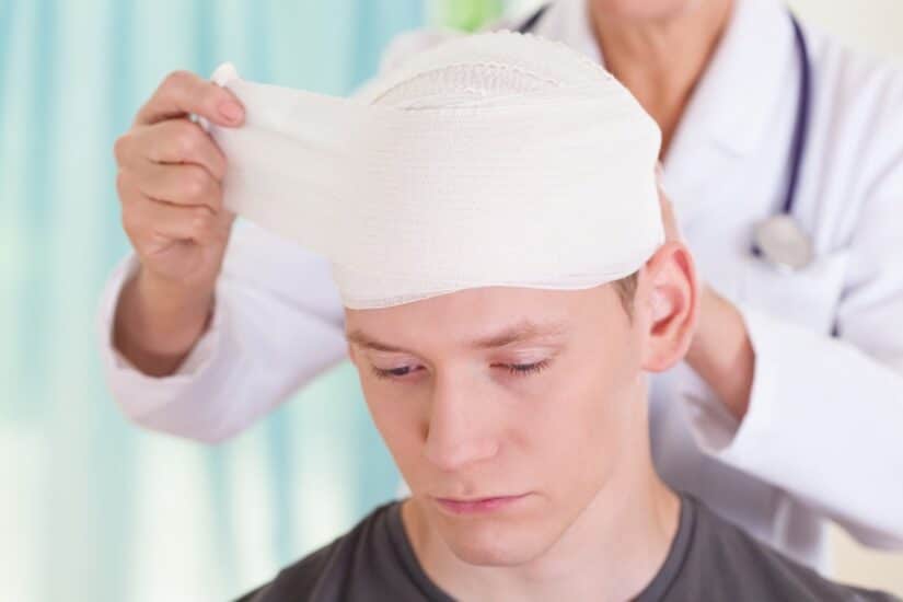 Photo of doctor bandaging a patients head