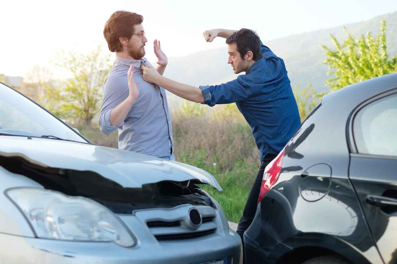 Two Angry Men Two Men Fighting Next To A Car Crash