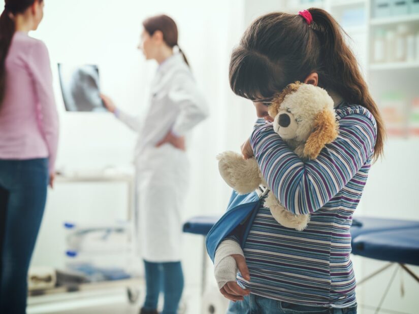 Child Holding A Teddy Bear