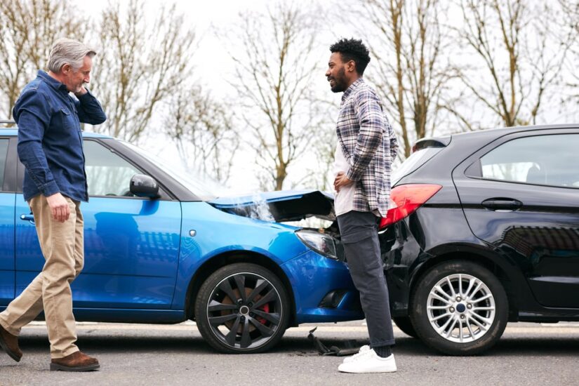 One Person Walking Towards The Other Person To Talk About The Car Accident