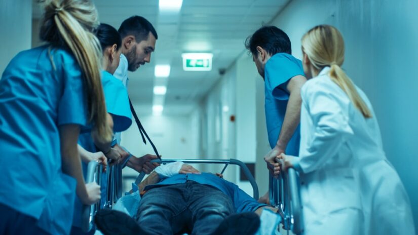 Patient Being Pushed On A Bed By Doctors