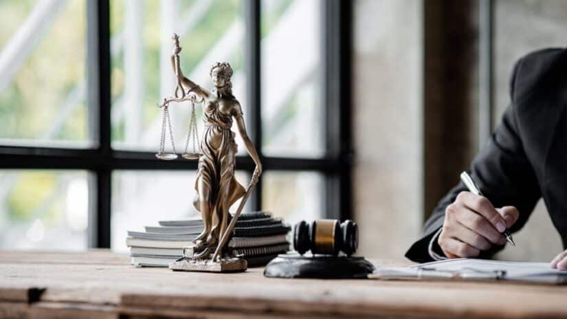 Themis statue on the table next to lawyer