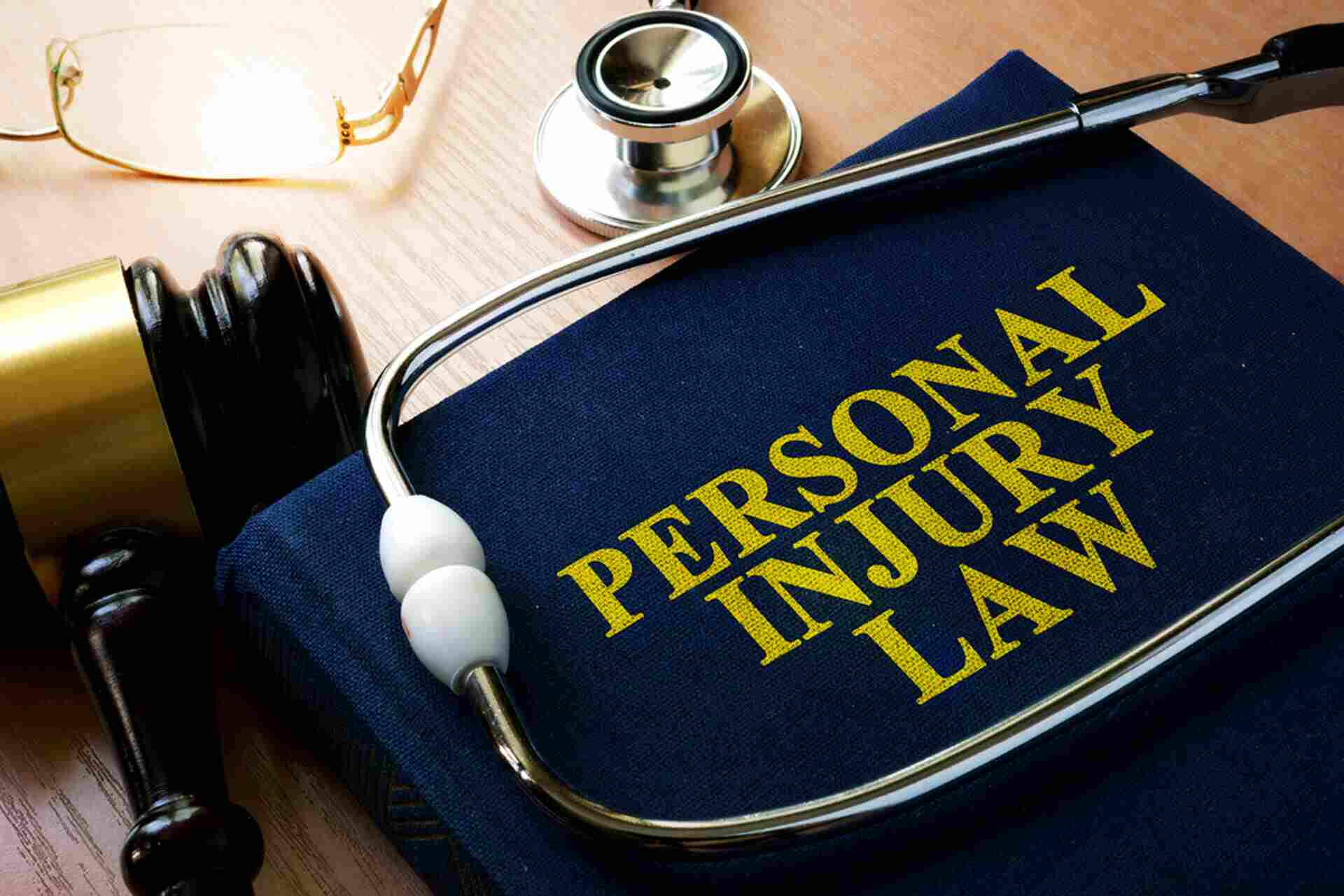 Personal Injury Law book with gavel and stethoscope.